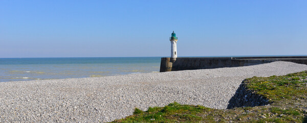 Panoramique sur la plage de galets et le phare de Saint-Valery-en-Caux (76460) sous le ciel bleu,...