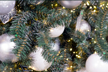 Obraz na płótnie Canvas Decorated christmas tree (new year) with many white balls, toys and sparkles