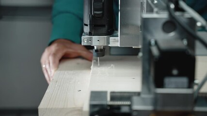 Automated CNC engraving machine with spindle for carving on wood, process of wood engraving in workplace using modern automated technology. Automated drilling machine, concept of industrial