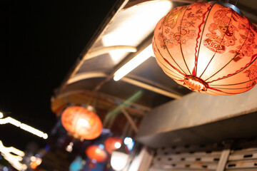 Fototapeta na wymiar Red Chinese style lanterns illuminate the night.