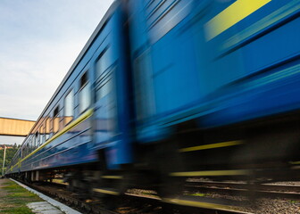 Naklejka premium a blue passenger train travels along the track