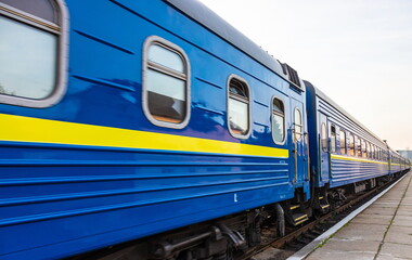 Fototapeta premium a blue passenger train travels along the track