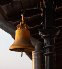 Fototapeta premium Copper old vintage bell. Decor concept element in the interior of a deck, cabin of a ship, restaurant, room, house, decorated on a marine theme