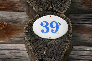 old enameled house number