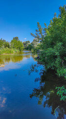 Landscape with a lake and clouds in the sky in the summer season