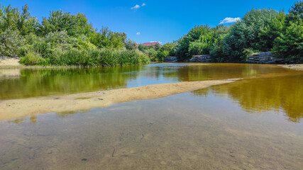 Landscape with a lake and clouds in the sky in the summer season