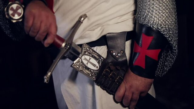 Templar knight drawing his sword