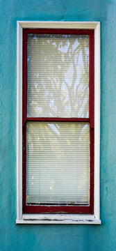Shabby Red Frame Window With Blue Wall.      