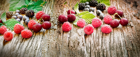 Fototapeta na wymiar Fresh organic berries, healthy forest fruit on rustic table 