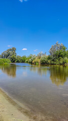Landscape with a lake and clouds in the sky in the summer season
