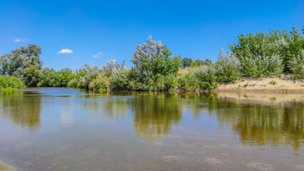 Landscape with a lake and clouds in the sky in the summer season