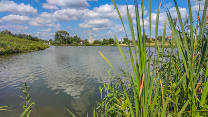Landscape with a lake and clouds in the sky in the summer season
