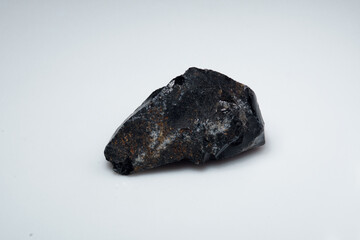 Natural black obsidian stone on white background