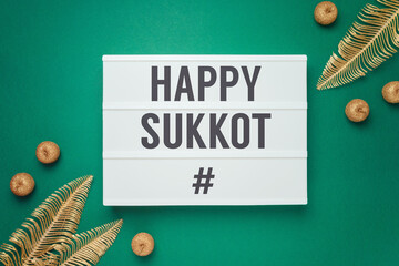 Jewish holiday Sukkot concept with decorations over green background