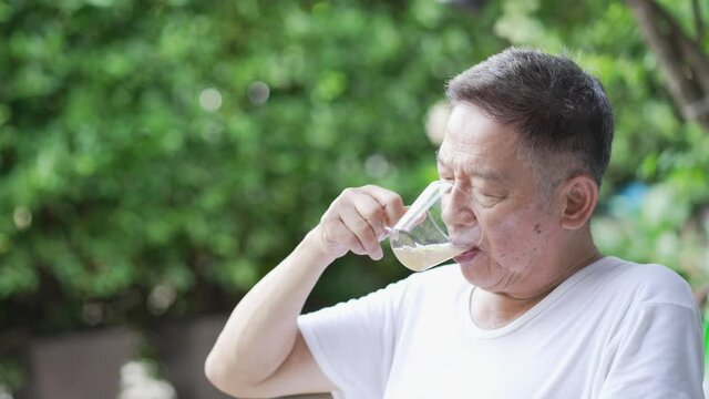 senior asian man drinking tea in morning