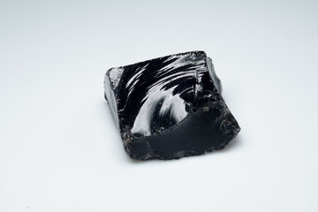 Natural black obsidian stone on white background
