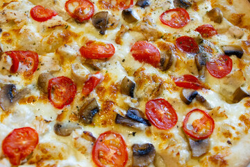 fresh whole pizza with mushrooms, pepperoni sausage and onions. Close-up view, background.