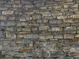 The background is the ancient masonry of the tower.