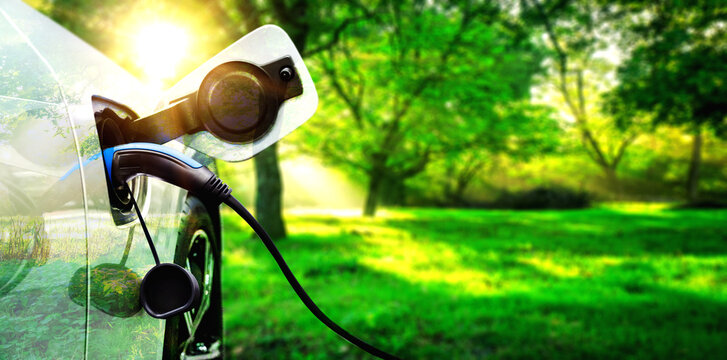EV charging station for electric car in concept of green energy and eco power produced from sustainable source to supply to charger station in order to reduce CO2 emission .