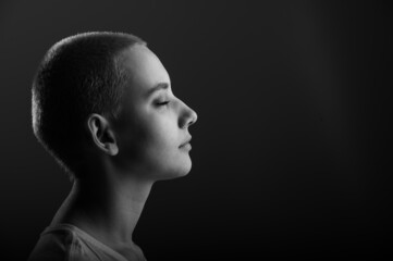 Portrait of pensive young woman with short hair on white background. Copy space