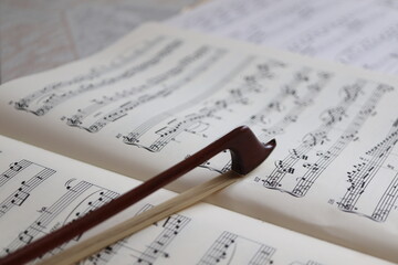 close up of a bow on musical scores 