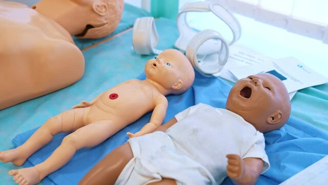 Infant dolls for medical experiences. Plastic baby models on the table in studying room for students in medical university. Close-up.