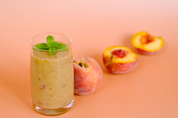 Top view of fresh healthy smoothie in a glass made of peach, banana and berries. Creative concept of healthy detox drink, diet or vegetarian food concept. Copy space.