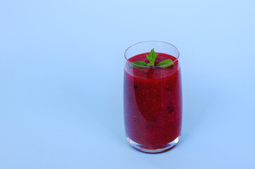 Top view of fresh delicious smoothie in a glass made of berries, chia seeds with mint. Creative concept of healthy detox drink, diet or vegetarian food concept. Copy space.