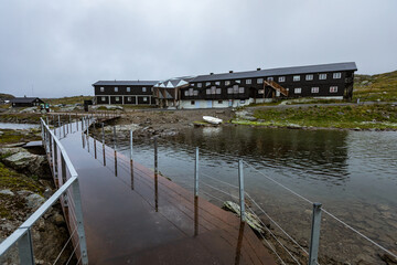 Metal bridge path leading to mountain lodge 