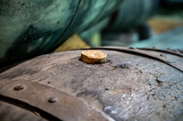 Old porto lodge with rows of oak wooden casks for slow aging of fortified ruby or tawny porto wine in Vila Nova de Gaia, Portugal