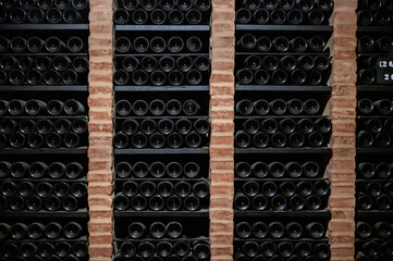 Bottles of vintage fortified ruby or tawny porto wine in old cellars of Vila Nova de Gaia, Portugal