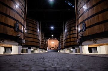 Old porto lodge with rows of oak wooden casks for slow aging of fortified ruby or tawny porto wine...