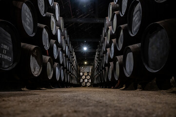 Old porto lodge with rows of oak wooden casks for slow aging of fortified ruby or tawny porto wine...