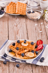 Waffles with blueberries, bananas and honey.