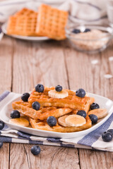 Waffles with blueberries, bananas and honey.
