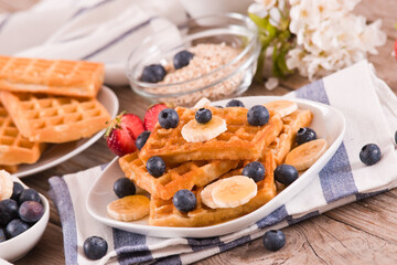 Waffles with blueberries, bananas and honey.