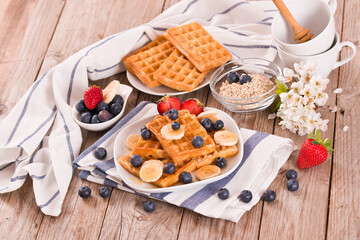 Waffles with blueberries, bananas and honey.