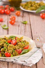 Fusilli pasta with cherry tomatoes and peas.