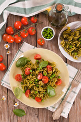 Fusilli pasta with cherry tomatoes and peas.