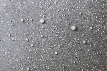 Water drops on smooth surface, grey background