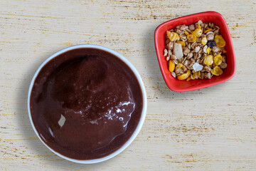bowl of açai and granola on the patina table