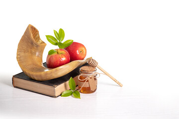 Red apples, Shofar,  honey  Torah book on white background, Rosh Hashanah (Jewish New Year holiday)...