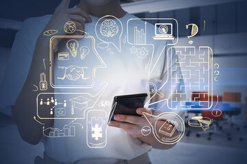 Businesswoman in t-shirt is standing at workplace and surfing smartphone