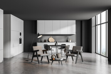 Corner of panoramic grey kitchen with seating area and round dining table