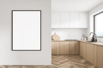 Poster near kitchen corner with wooden and white cabinet doors