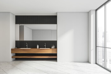Fototapeta na wymiar White bathroom with black tile and wood alike vanity area