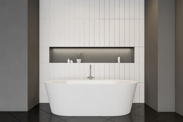 Oval bathtub in grey and white bathroom
