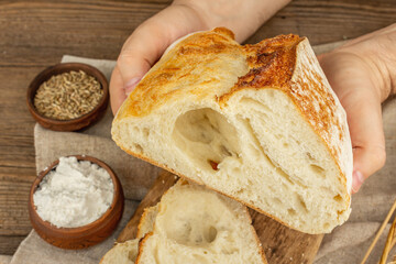 Male hands are holding freshly baked bread