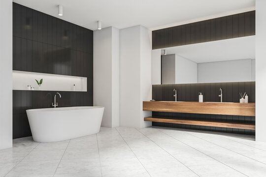 Minimalist white and black bathroom space with wooden vanity. Corner view.