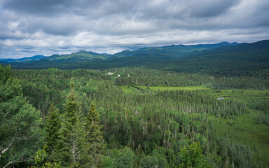 Obraz premium View on the Valin river and the Valin Mountain in summer from the Mirador hiking trail in Monts Valin National Park, in Quebec (Canada)